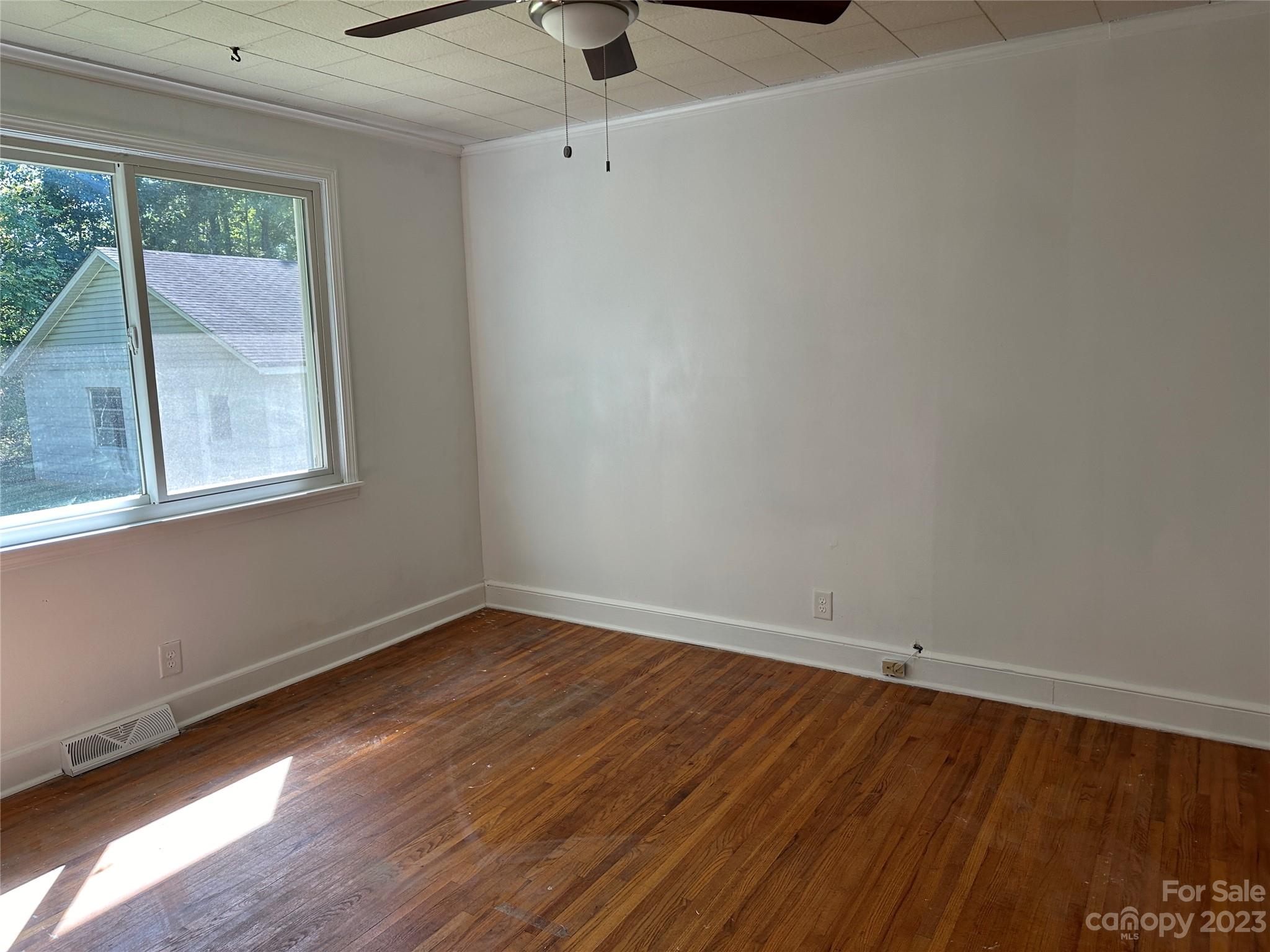 4205 Titman Road Gastonia, NC 28056 - Photo 9 of 16 an empty room with wooden floor and windows