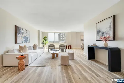 a living room with furniture a table and painting on the wall
