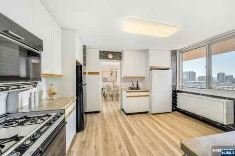 a kitchen with a stove a refrigerator and a sink