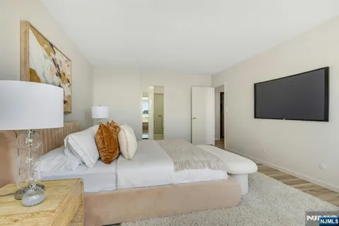 a bedroom with a bed and a flat screen tv