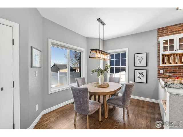 a view of a dining room with furniture window and wooden floor