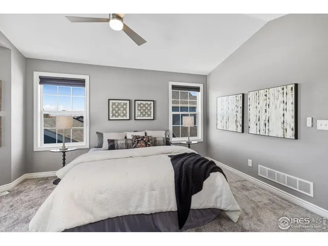 a bedroom with a bed and glass windows