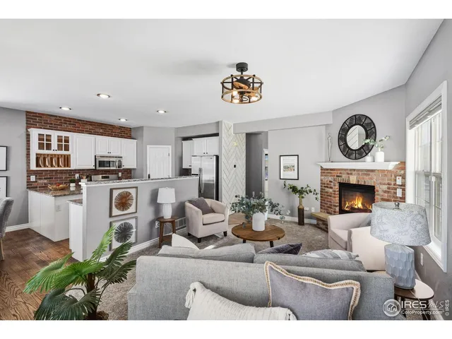 a living room with fireplace furniture and a fireplace