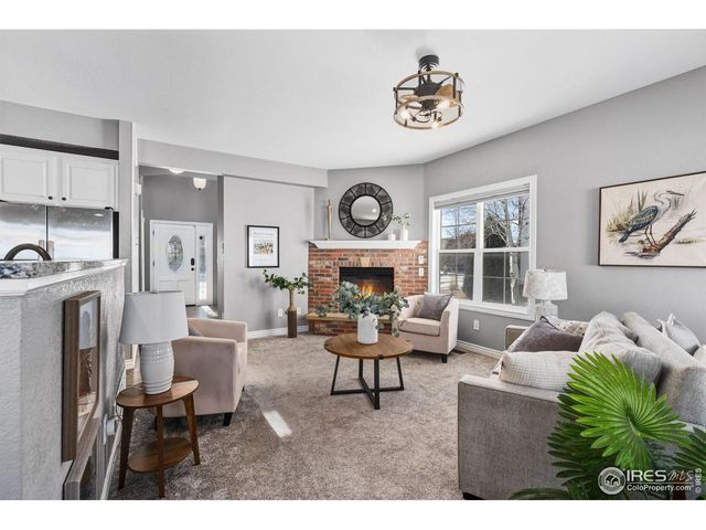a living room with furniture a clock and a fireplace