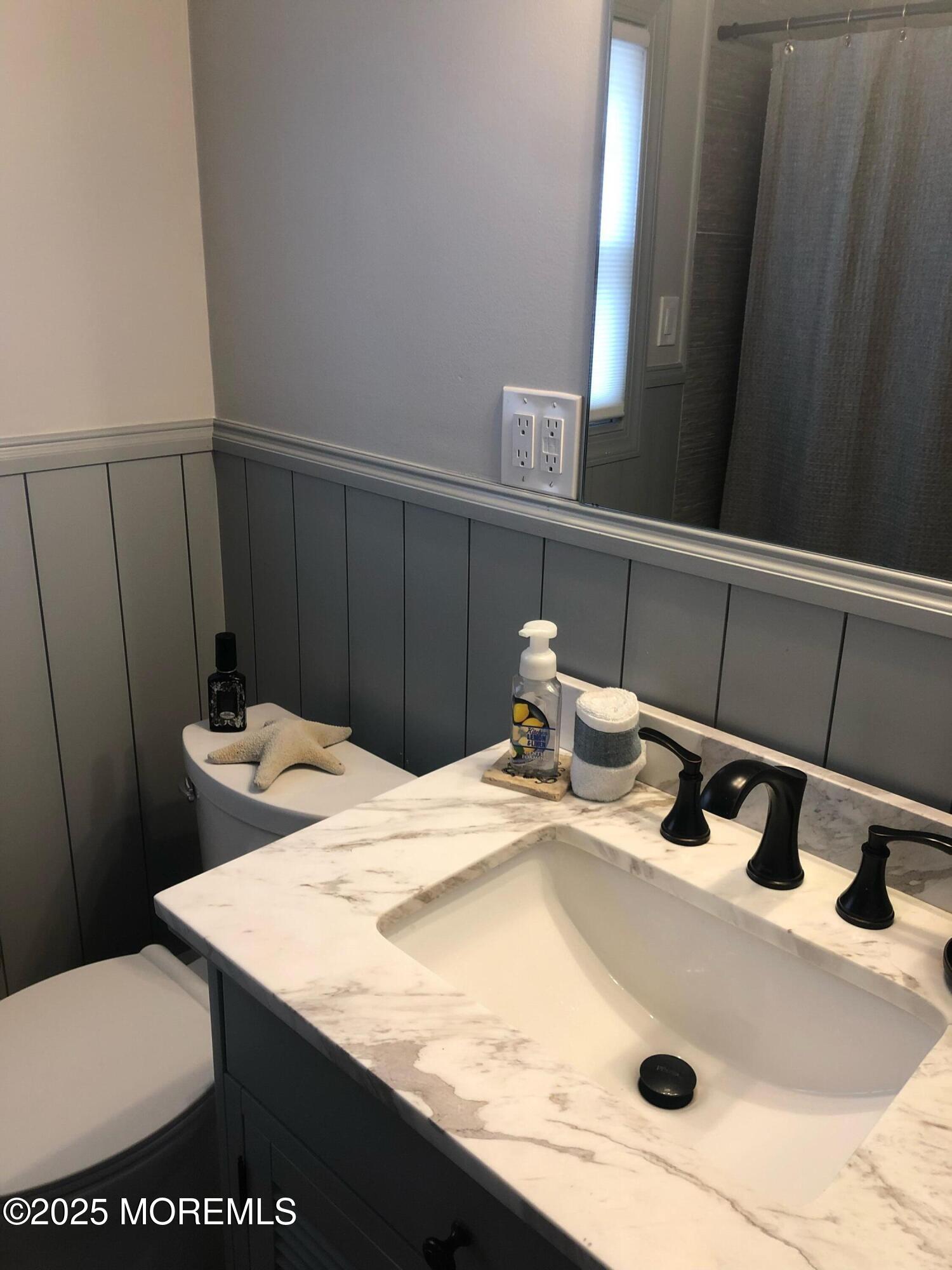 30 N Street Seaside Park, NJ 08752 - Photo 14 of 38 a bathroom with a sink toilet and vanity