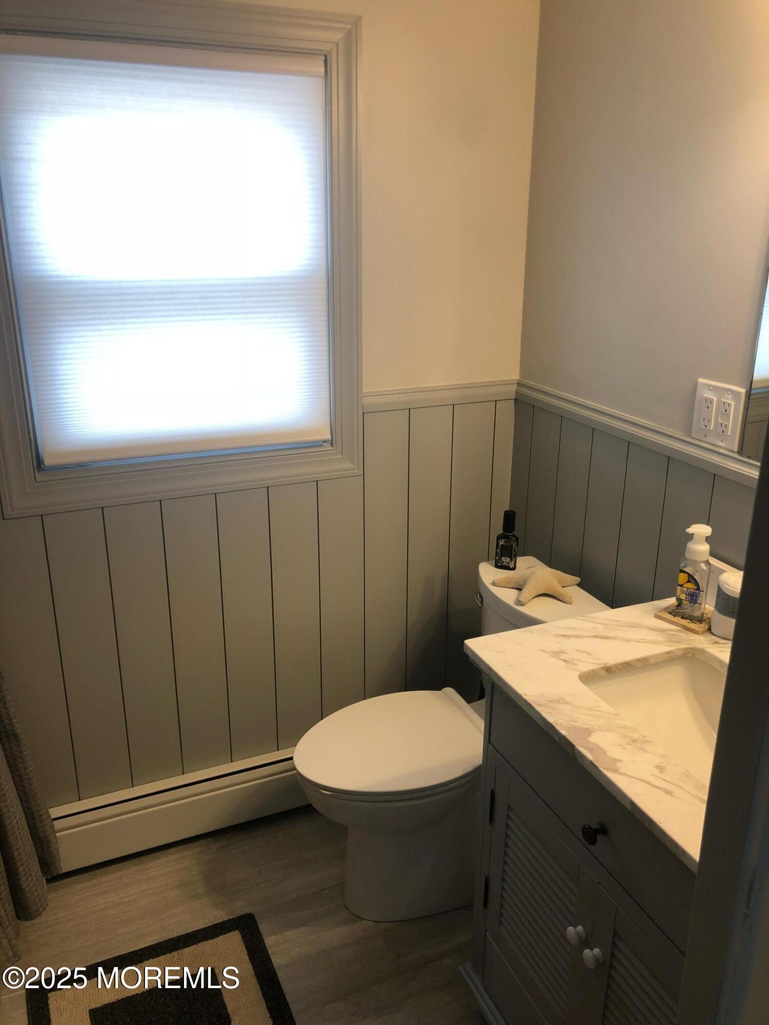 30 N Street Seaside Park, NJ 08752 - Photo 15 of 38 a bathroom with a sink a toilet and a window