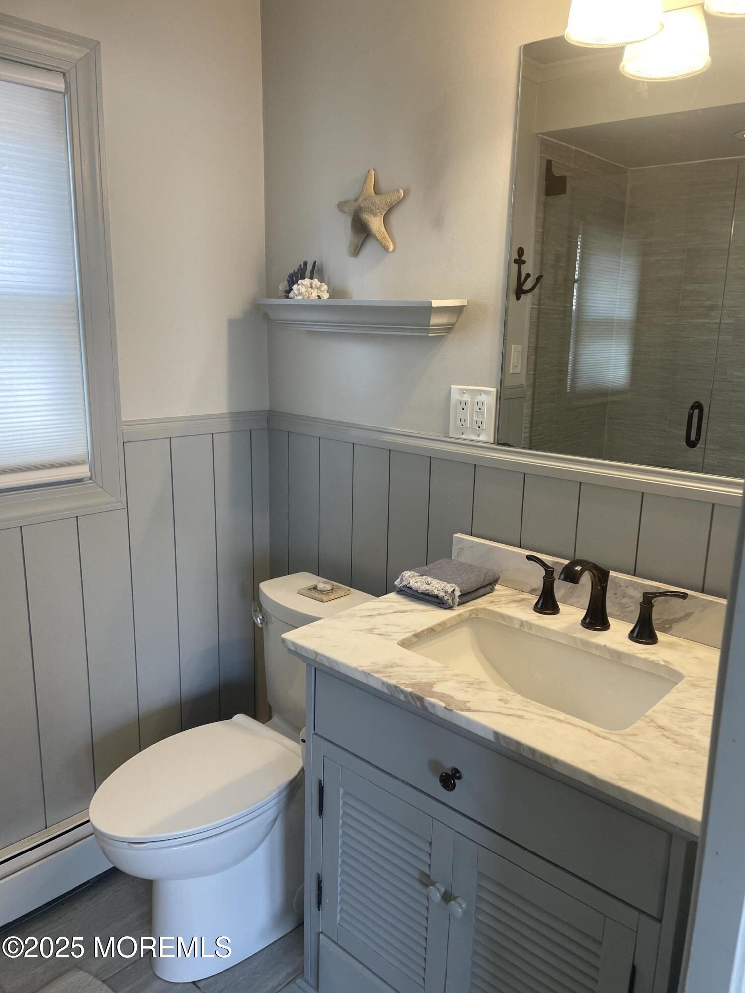 30 N Street Seaside Park, NJ 08752 - Photo 31 of 38 a bathroom with a granite countertop toilet sink and mirror