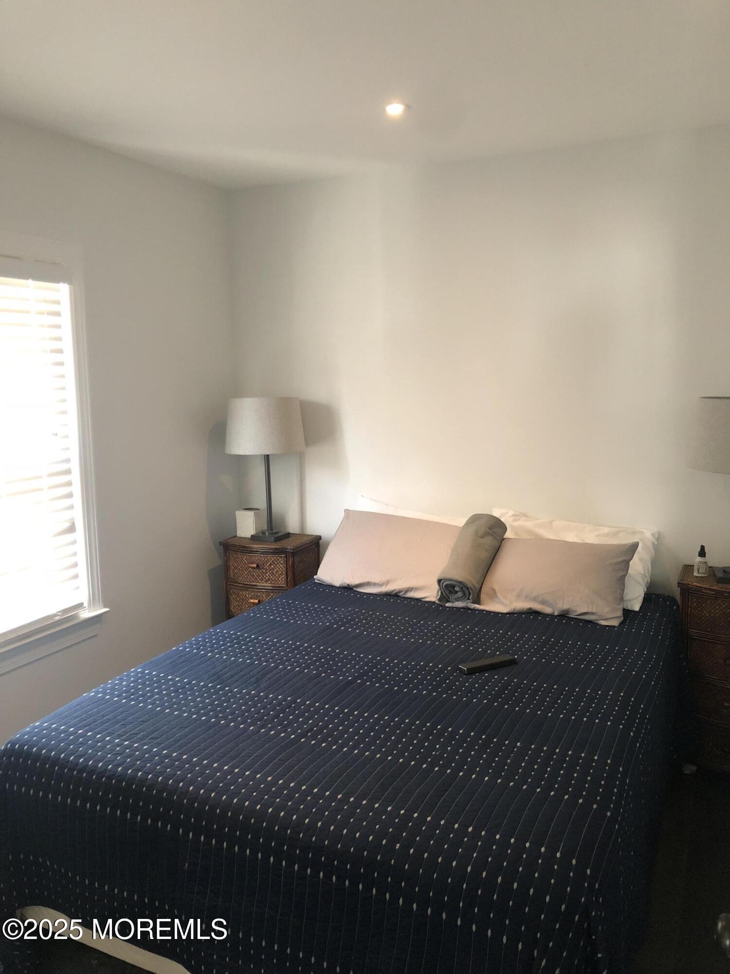 30 N Street Seaside Park, NJ 08752 - Photo 35 of 38 a bedroom with a bed and a lamp