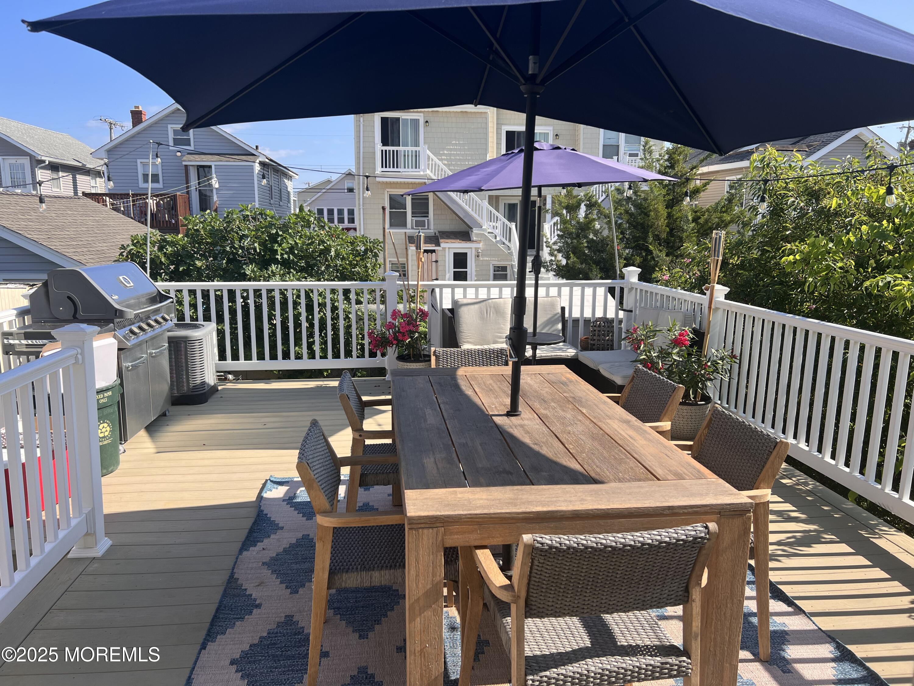 30 N Street Seaside Park, NJ 08752 - Photo 36 of 38 a view of a patio with a table chairs and a umbrella