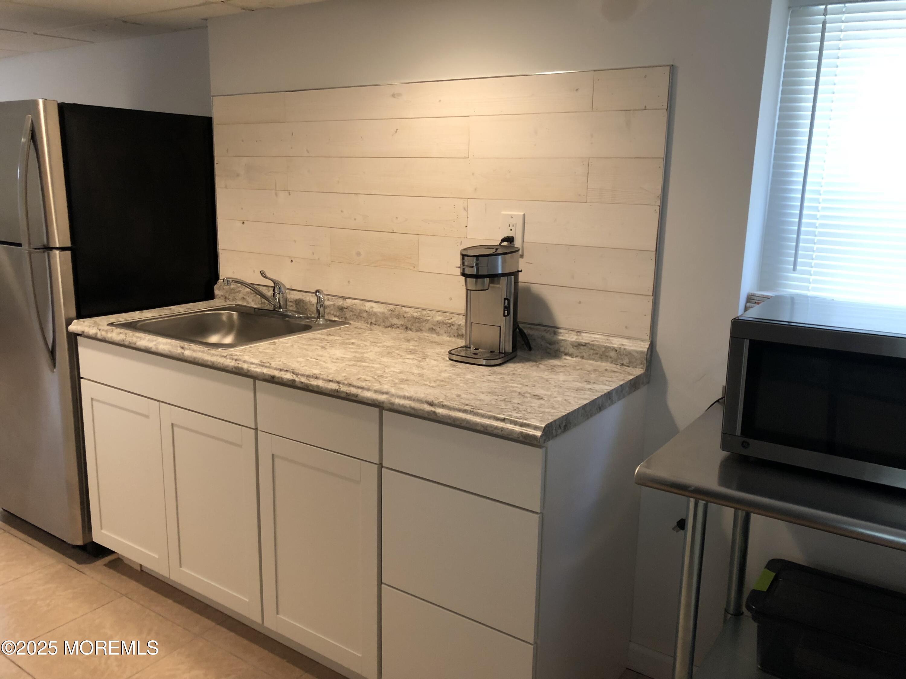 30 N Street Seaside Park, NJ 08752 - Photo 9 of 38 a bathroom with a granite countertop sink and a mirror