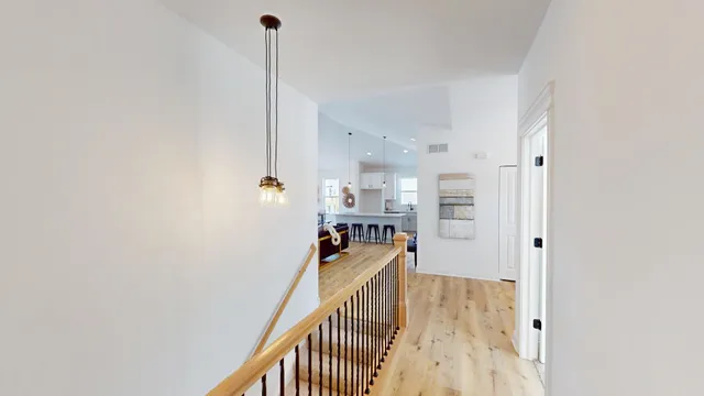 a view of a kitchen with furniture and wooden floor