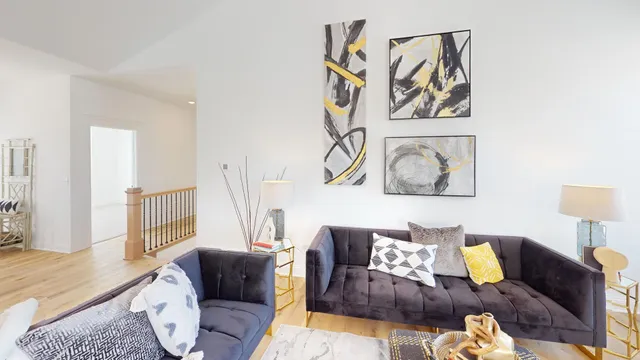 a living room with furniture and wall painting