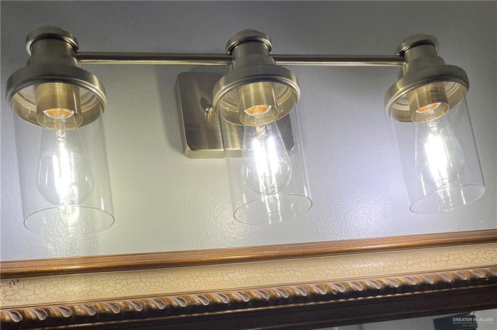 2113 South 3rd Street McAllen, TX 78503 - Photo 11 of 26 a bathroom with a sink and a mirror