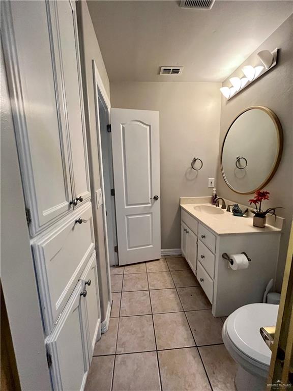 2113 South 3rd Street McAllen, TX 78503 - Photo 17 of 26 a bathroom with a sink mirror vanity and toilet