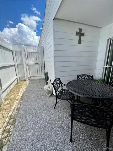 a backyard of a house with table and chairs