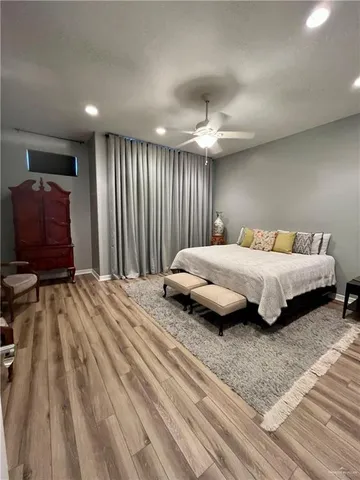 a bedroom with a bed and a view of balcony
