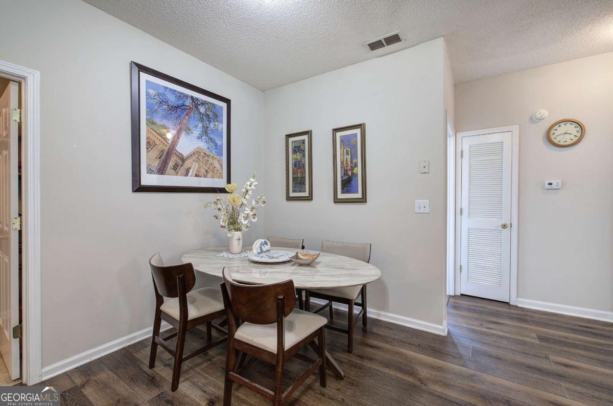 150 Old Mill Road, Unit 123 Cartersville, GA 30120 - Photo 11 of 27 a view of a dining room with furniture and wooden floor
