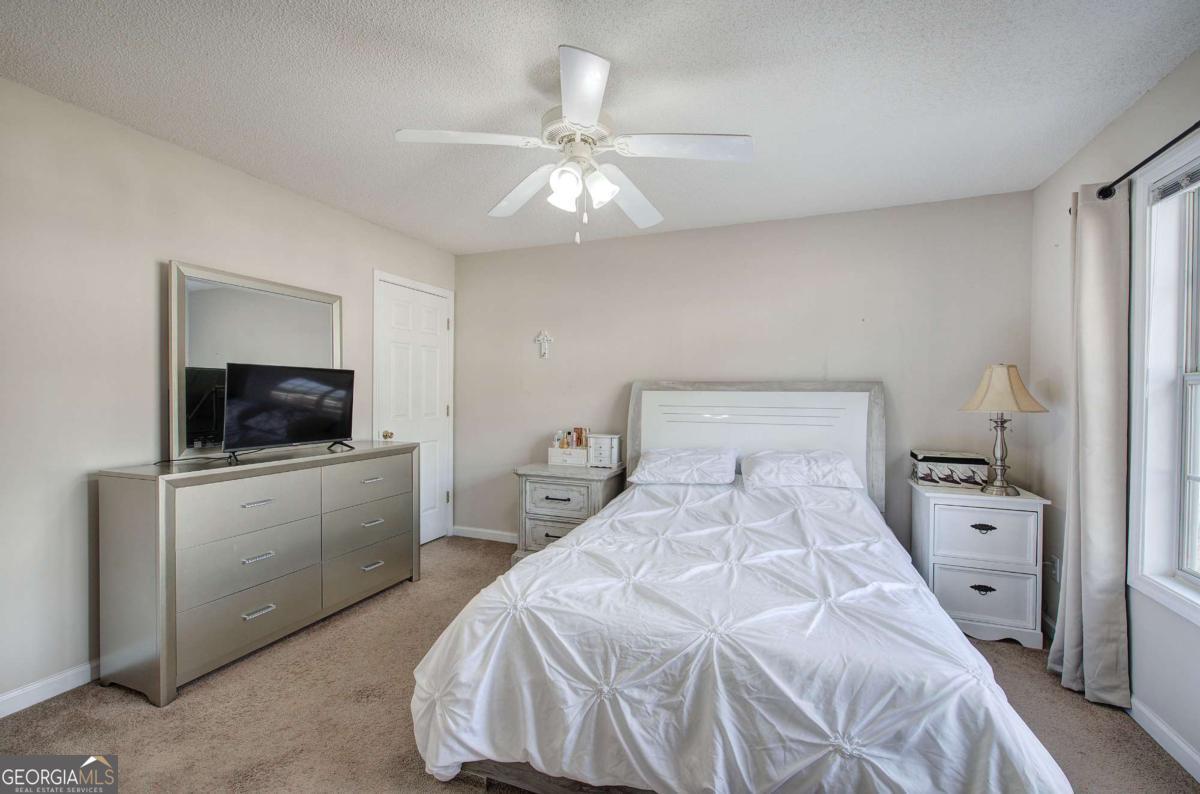 150 Old Mill Road, Unit 123 Cartersville, GA 30120 - Photo 14 of 27 a bedroom with a bed and a flat screen tv