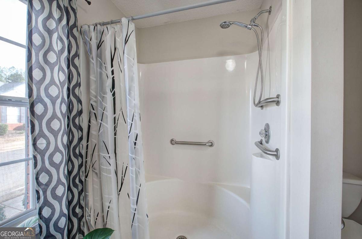 150 Old Mill Road, Unit 123 Cartersville, GA 30120 - Photo 16 of 27 a bathroom with a shower curtain and a shower curtain