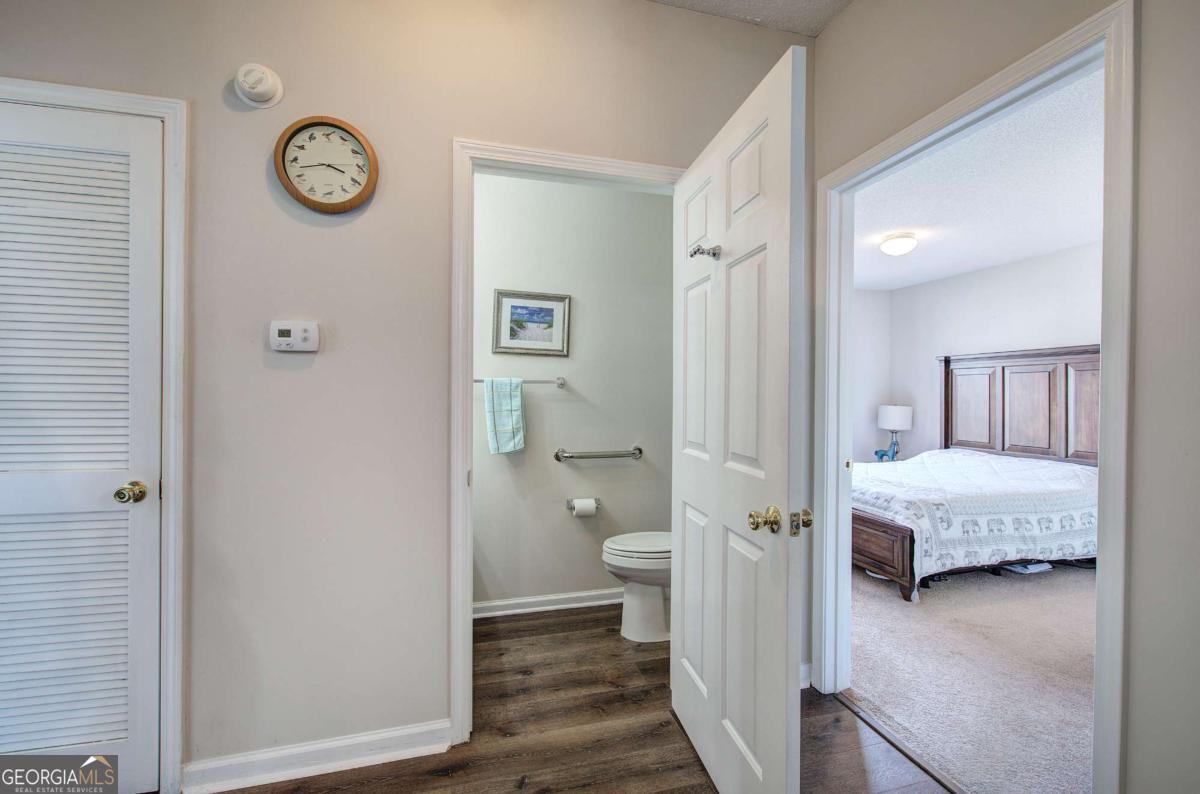 150 Old Mill Road, Unit 123 Cartersville, GA 30120 - Photo 17 of 27 a view of a bedroom with a hardwood floor and a ceiling fan