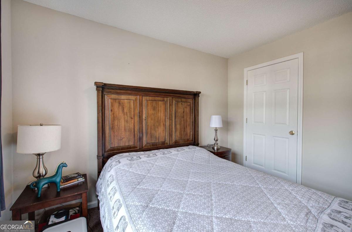 150 Old Mill Road, Unit 123 Cartersville, GA 30120 - Photo 20 of 27 a bedroom with a bed and a lamp on table