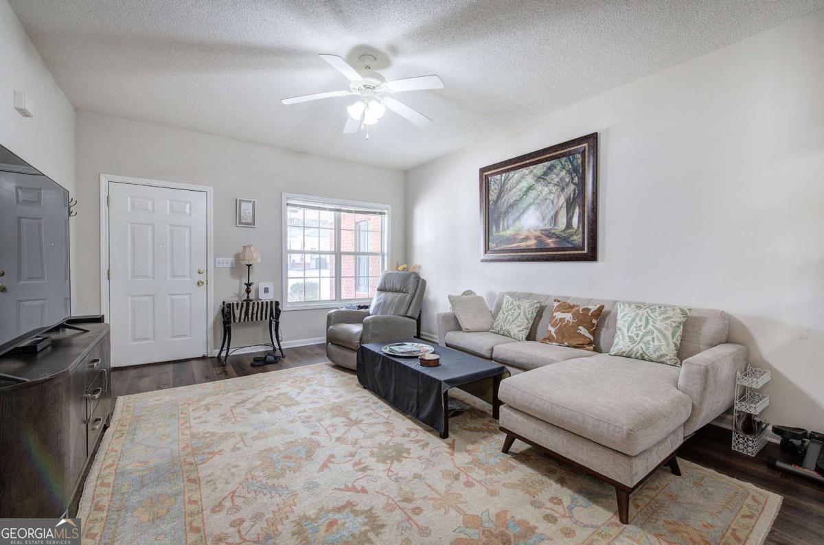 150 Old Mill Road, Unit 123 Cartersville, GA 30120 - Photo 6 of 27 a living room with furniture and a flat screen tv