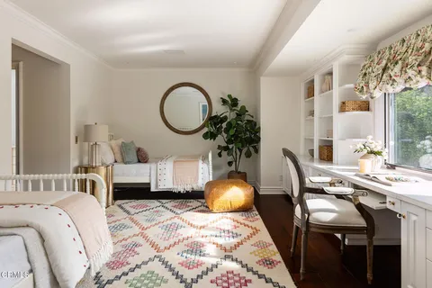 a living room with patio furniture and a chandelier