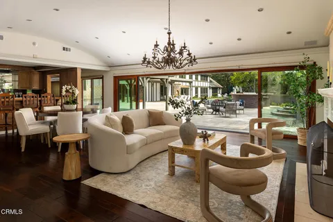 a front view of a house with swimming pool having outdoor seating