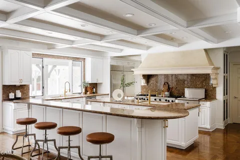 a kitchen with stainless steel appliances granite countertop a sink and a counter space