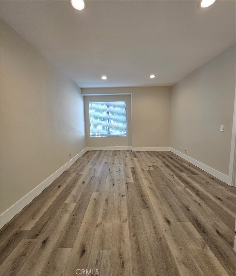 377 Huntington Irvine, CA 92620 - Photo 6 of 8 an empty room with wooden floor and windows