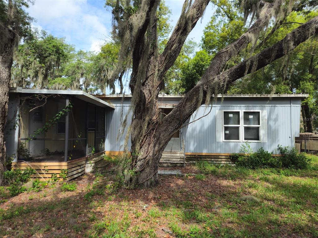 8603 Alafia Ridge Road Riverview, FL 33569 - Photo 5 of 13 a house with trees in the background
