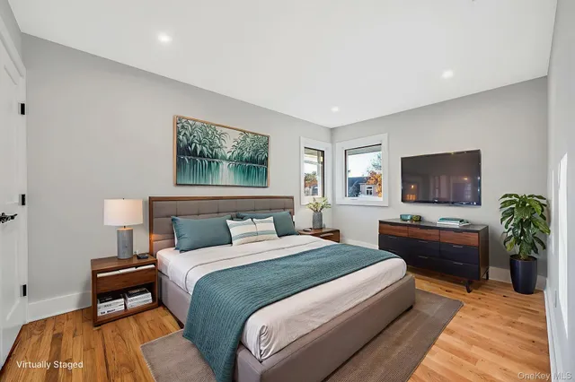 a bedroom with a large bed and a flat screen tv