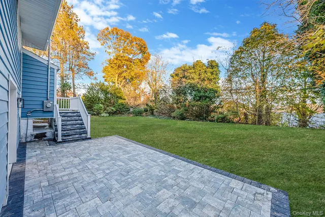 a view of a garden with large trees