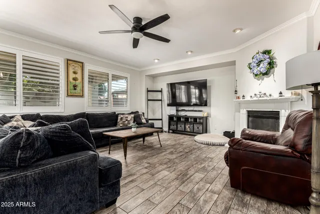 a living room with furniture a fireplace and a flat screen tv