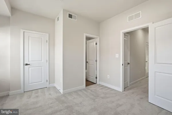 a view of an empty room with closet area