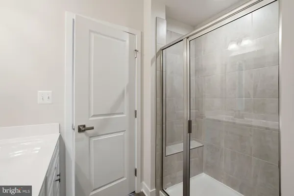 a bathroom with a glass shower door