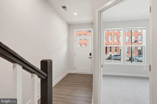 a view of an entryway with wooden floor and door