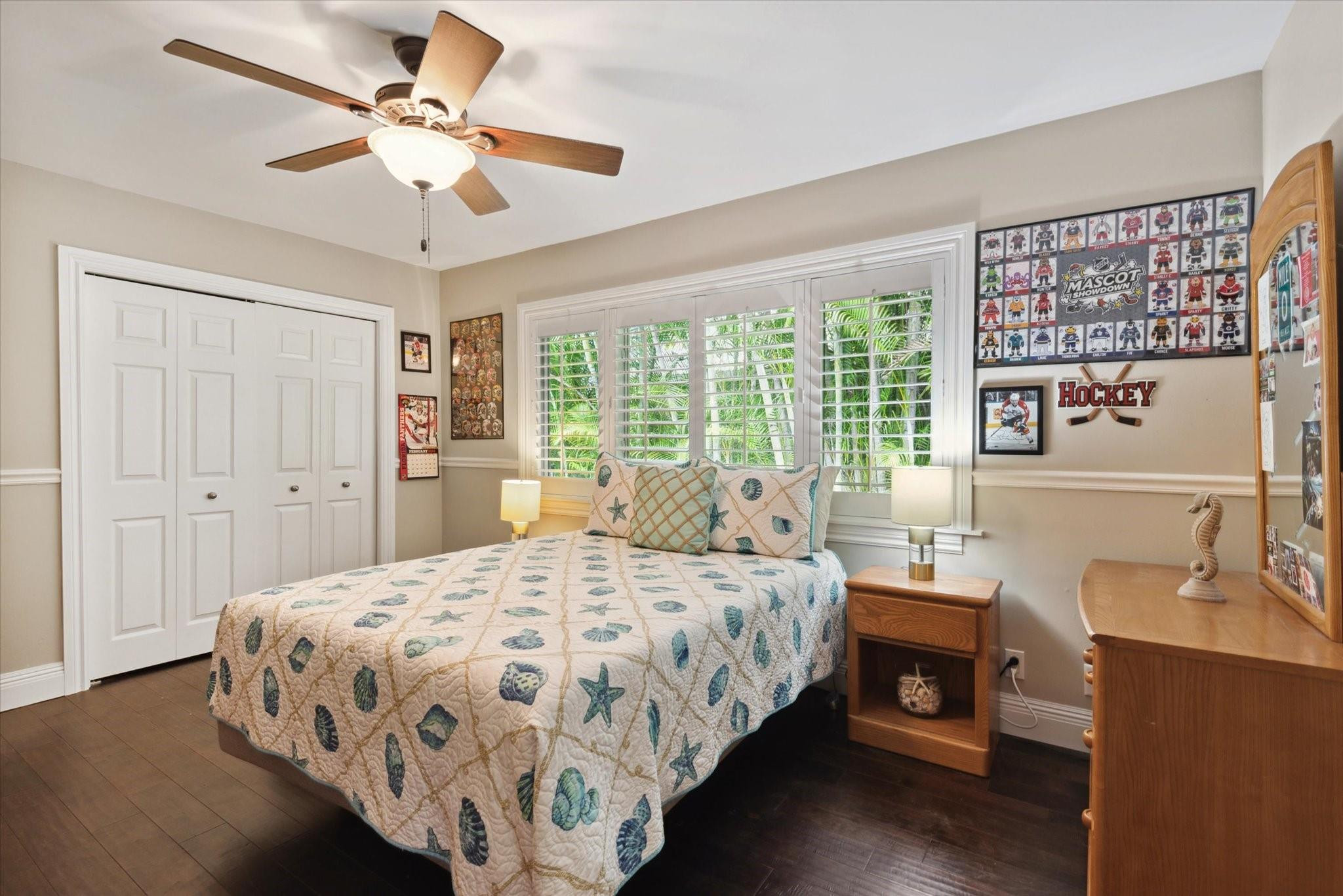 1055 Parkside Circle North Boca Raton, FL 33486 - Photo 13 of 24 a bedroom with a large bed and a chandelier