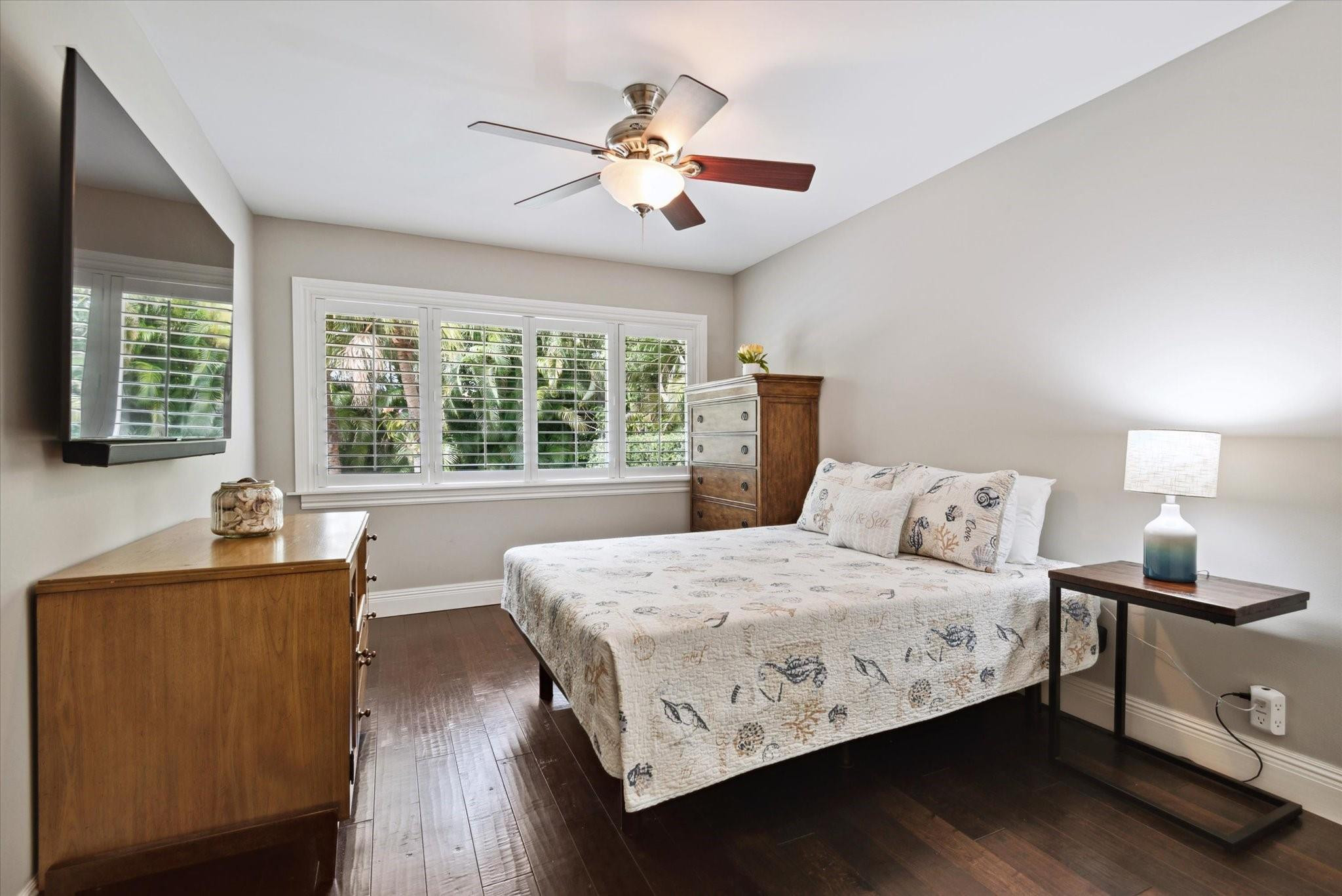 1055 Parkside Circle North Boca Raton, FL 33486 - Photo 14 of 24 a bedroom with a large bed and a chandelier