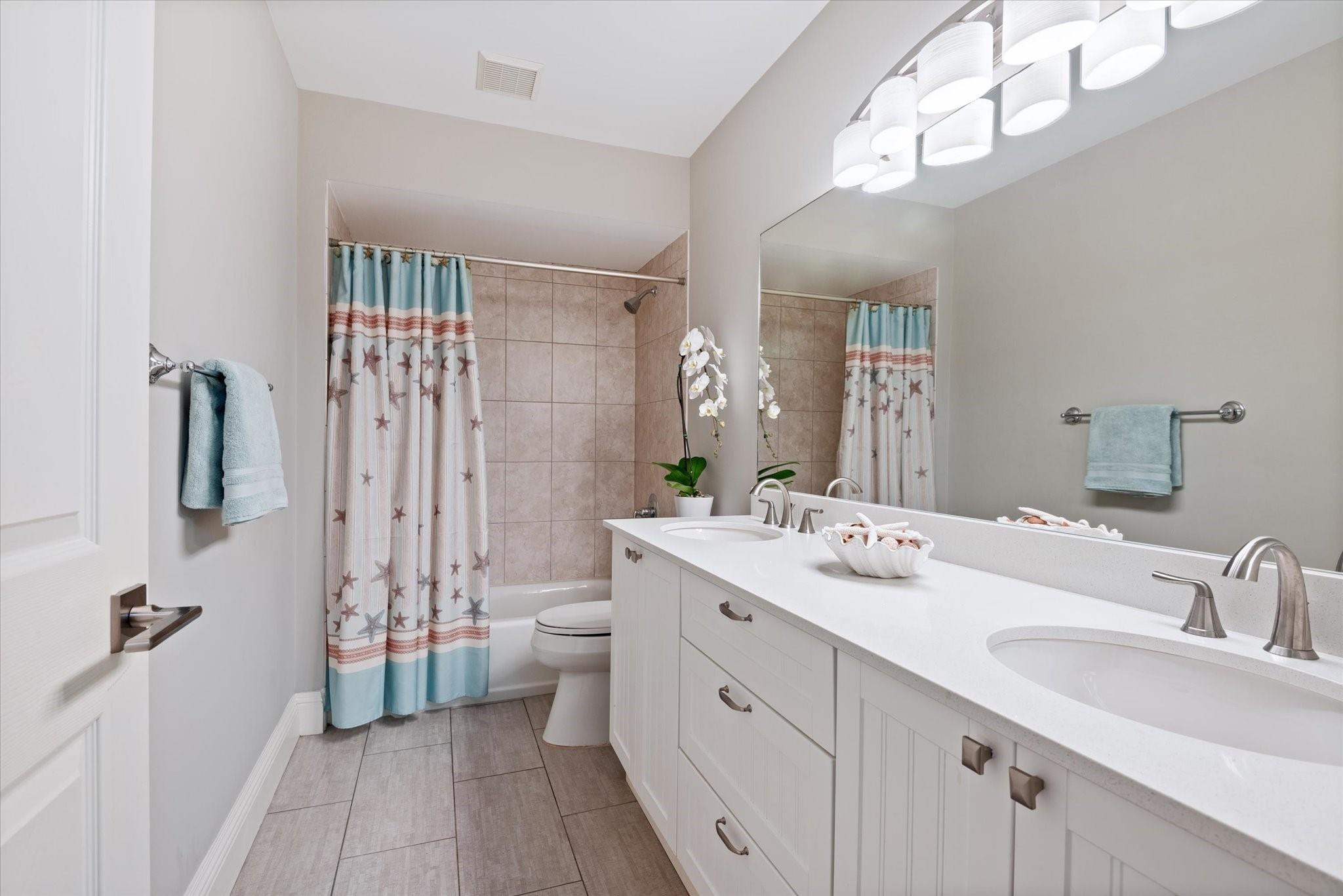 1055 Parkside Circle North Boca Raton, FL 33486 - Photo 16 of 24 a spacious bathroom with a double vanity sink mirror and toilet
