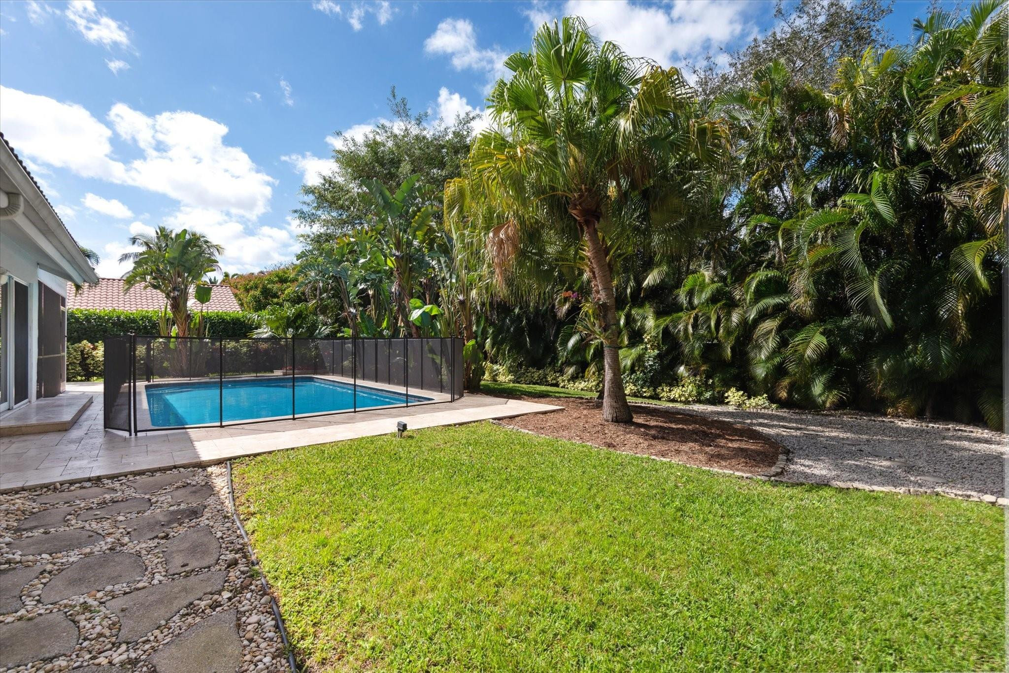 1055 Parkside Circle North Boca Raton, FL 33486 - Photo 21 of 24 a swimming pool with wooden fence
