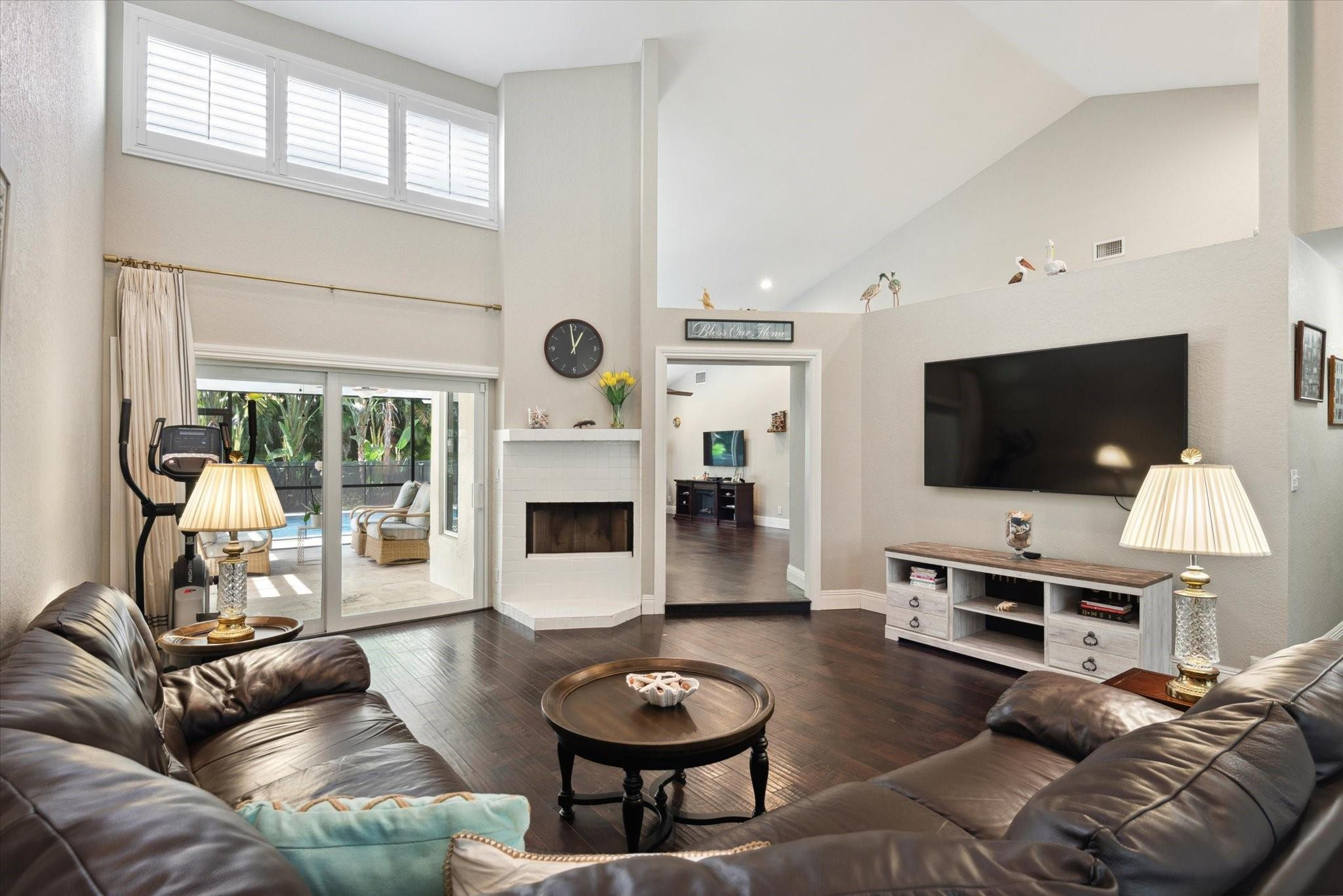 1055 Parkside Circle North Boca Raton, FL 33486 - Photo 3 of 24 a living room with furniture a flat screen tv and a floor to ceiling window