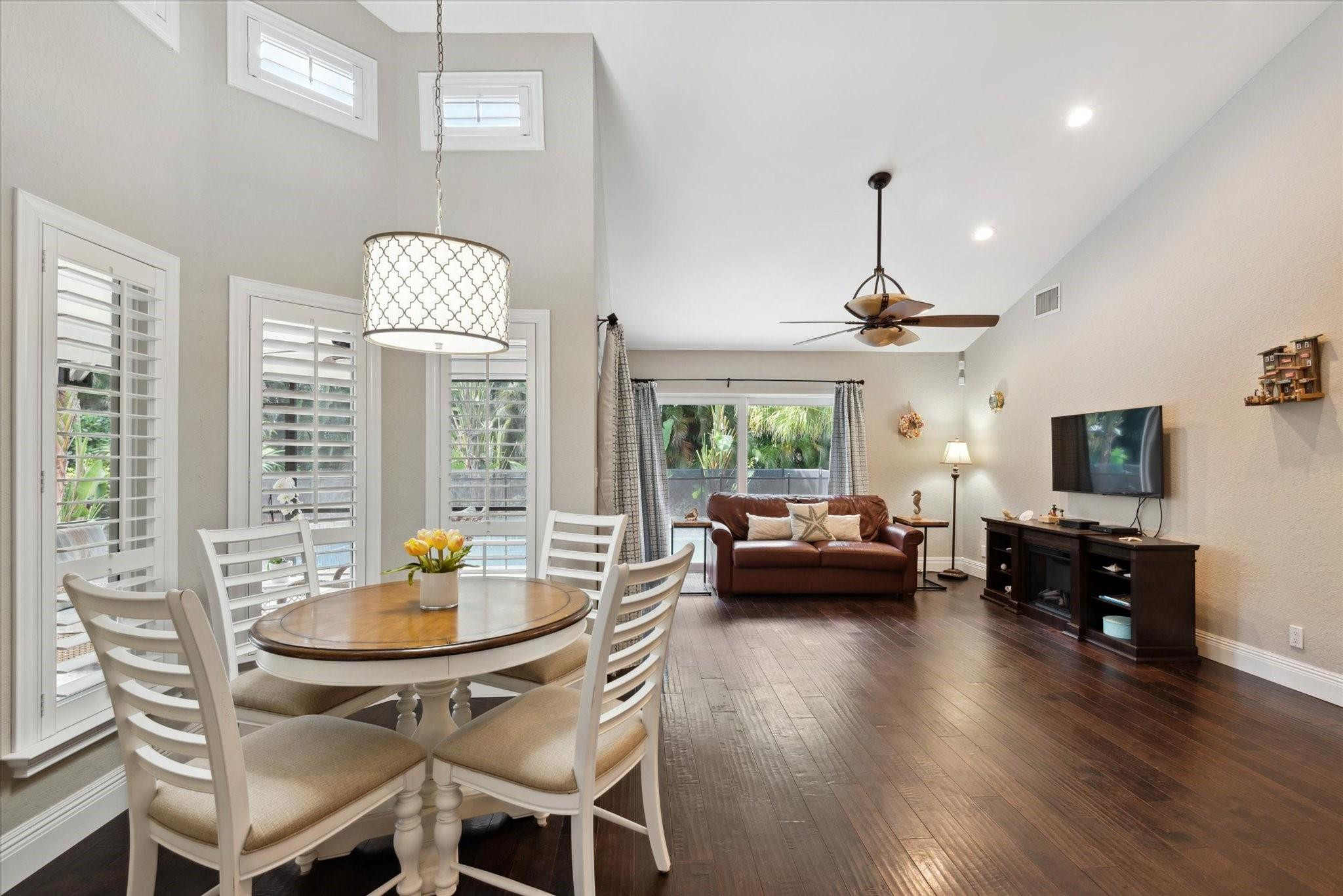 1055 Parkside Circle North Boca Raton, FL 33486 - Photo 5 of 24 a view of a dining room with furniture a chandelier and wooden floor