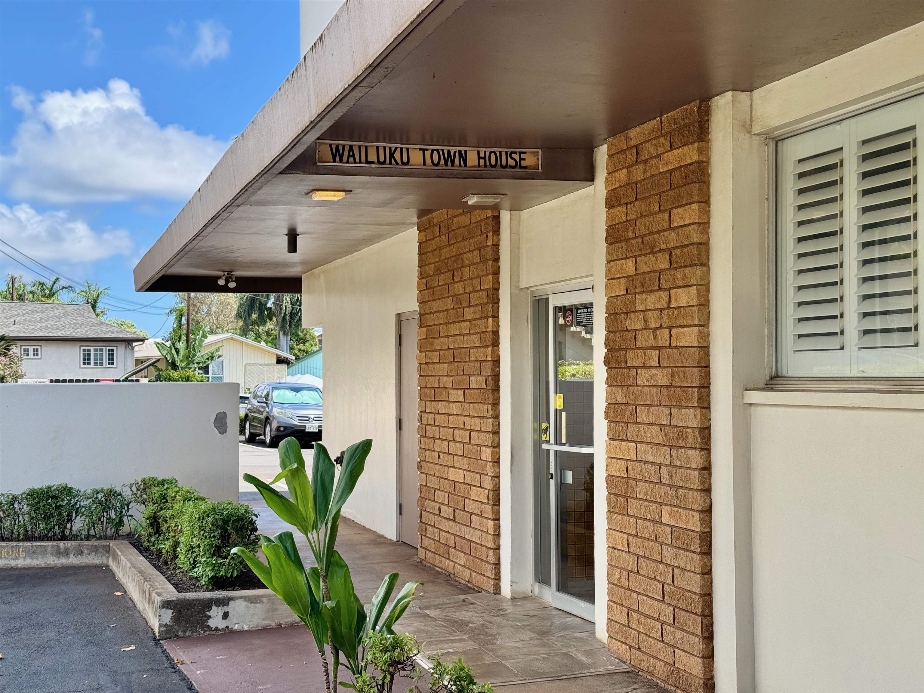 2158 Main Street, Unit 707 Wailuku, HI 96793 - Photo 4 of 27 a front view of a house with potted plants