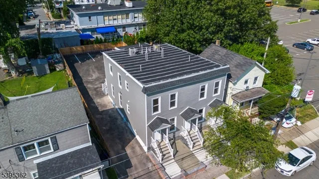 an aerial view of a house with backyard