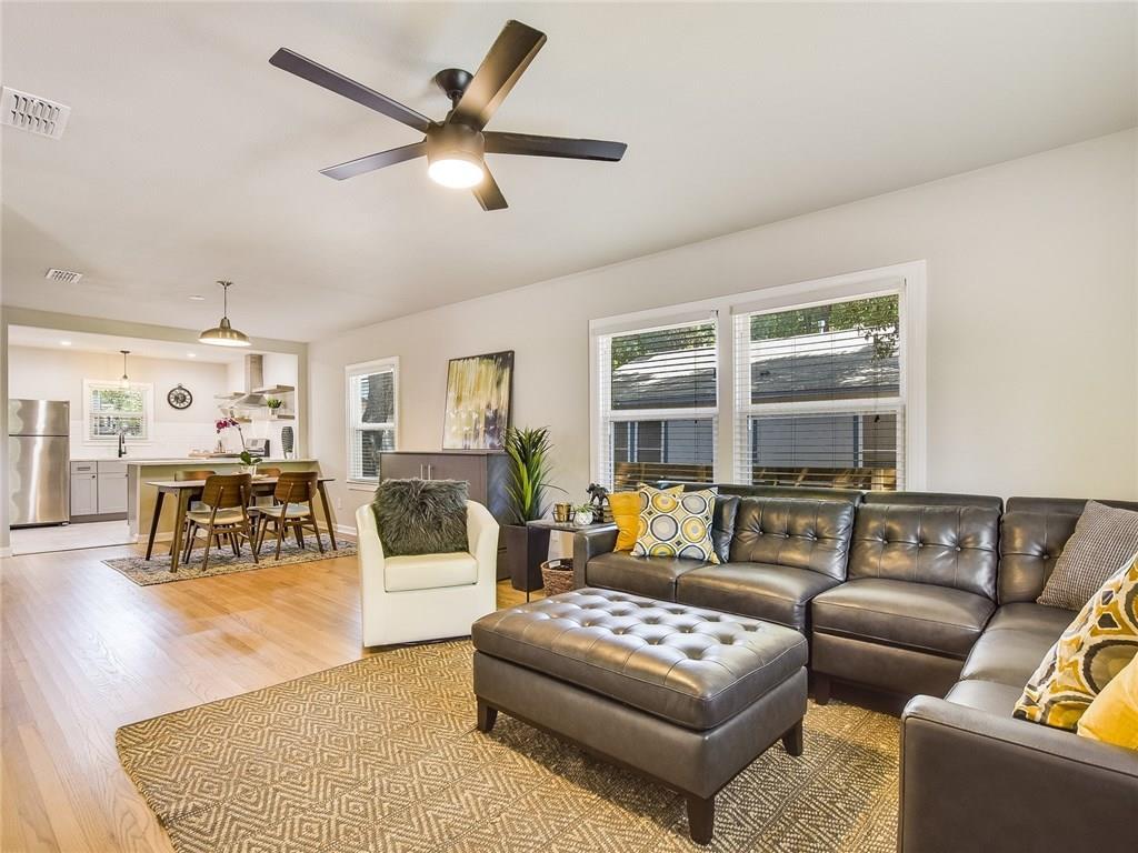 Spacious open living area with comfortable seating and seamless flow to dining and kitchen—ideal for professionals, roommates, or remote work.