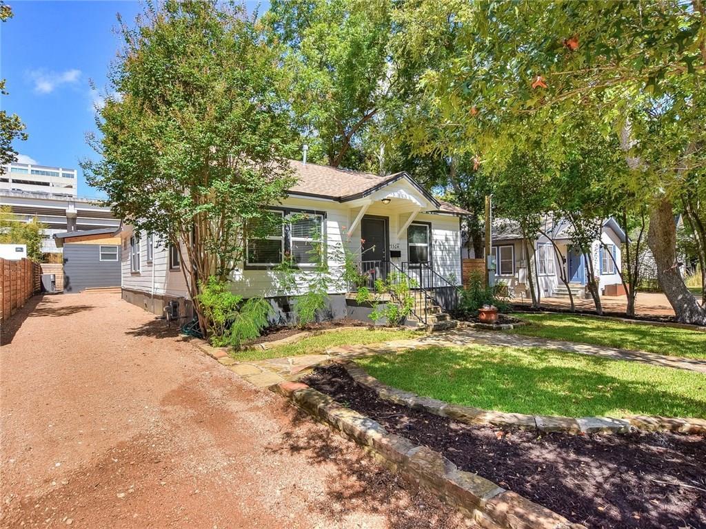 3304 Robinson Avenue, Unit 1 Austin, TX 78722 - Photo 12 of 13 Private driveway parking with covered awning and low-maintenance outdoor space—utilities and lawn care included for true turnkey living.