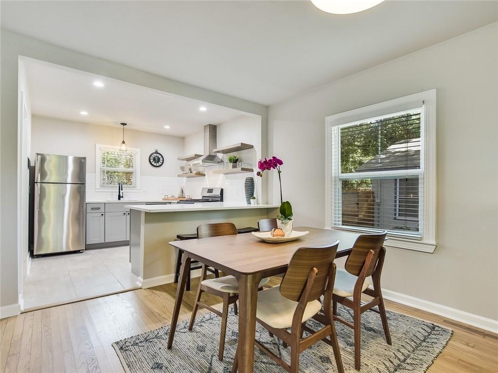 3304 Robinson Avenue, Unit 1 Austin, TX 78722 - Photo 3 of 13 Dedicated dining area with modern furnishings, natural light, and easy connection to the kitchen—perfect for everyday meals or casual gatherings.