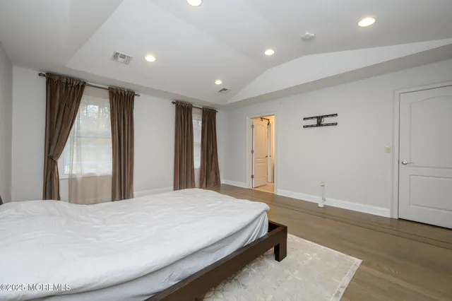 a spacious bedroom with a large bed and a large window