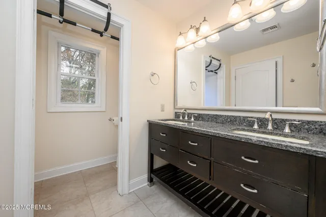 a bathroom with a double vanity sink and a mirror
